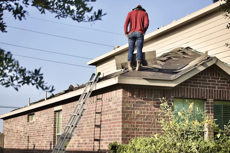 Professional roofer working on a residential roof in North River Crossing